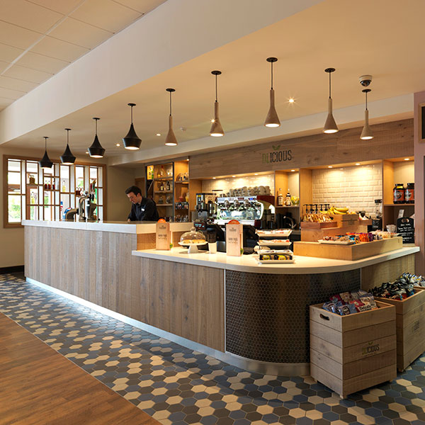 wood based cafe counter area with food and drink