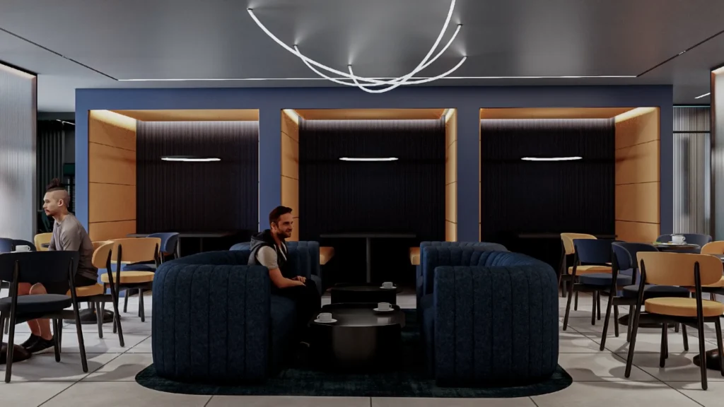 Cafe area with large blue sofas, surrounded by blue walls and dark grey doors, featuring multiple seating options.